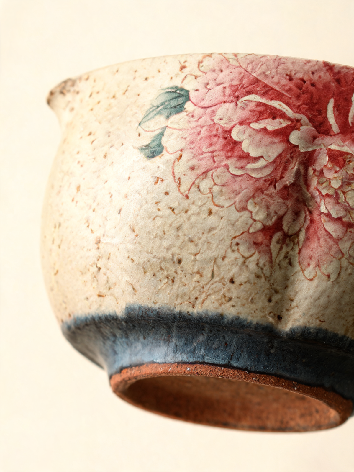 Detail of the pink peony motif on cream and beige ceramic