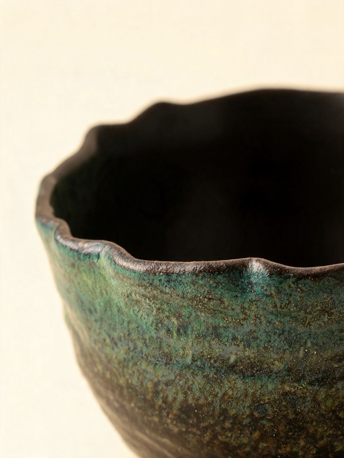 Detail of the moss green to brown black reactive glaze gradient