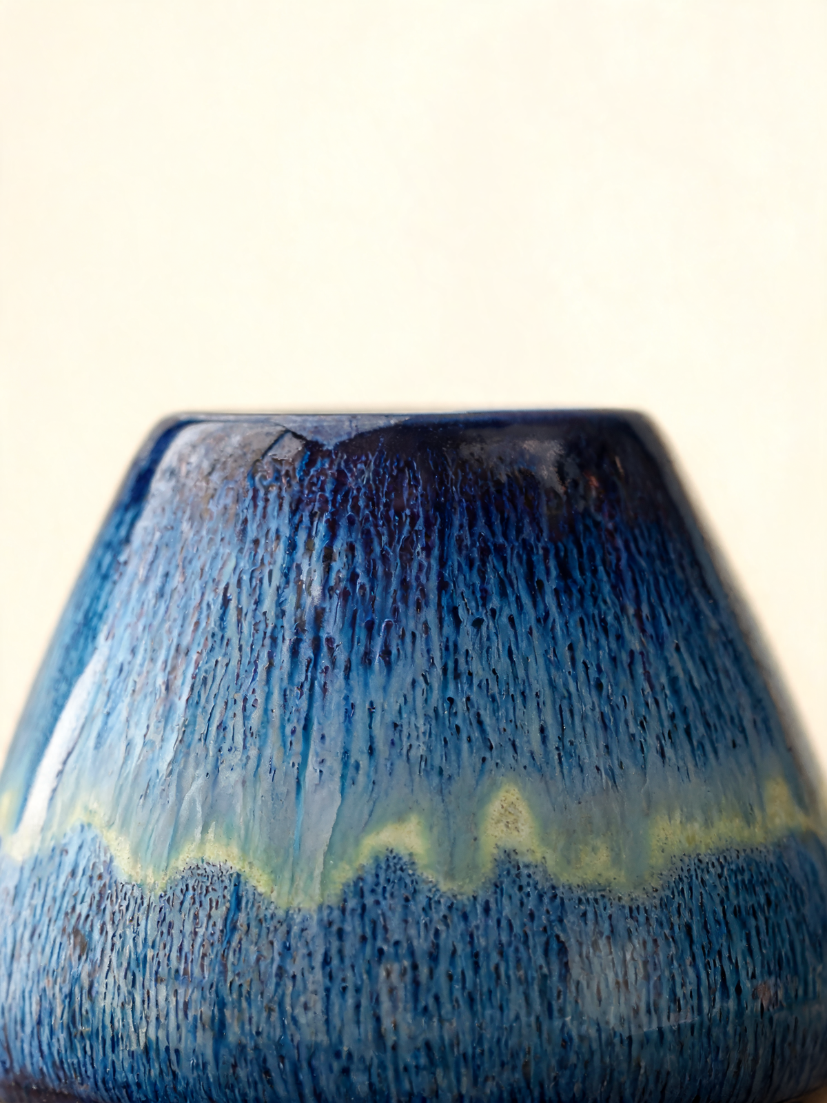 Detail of the cream and gold band crossing the indigo glaze