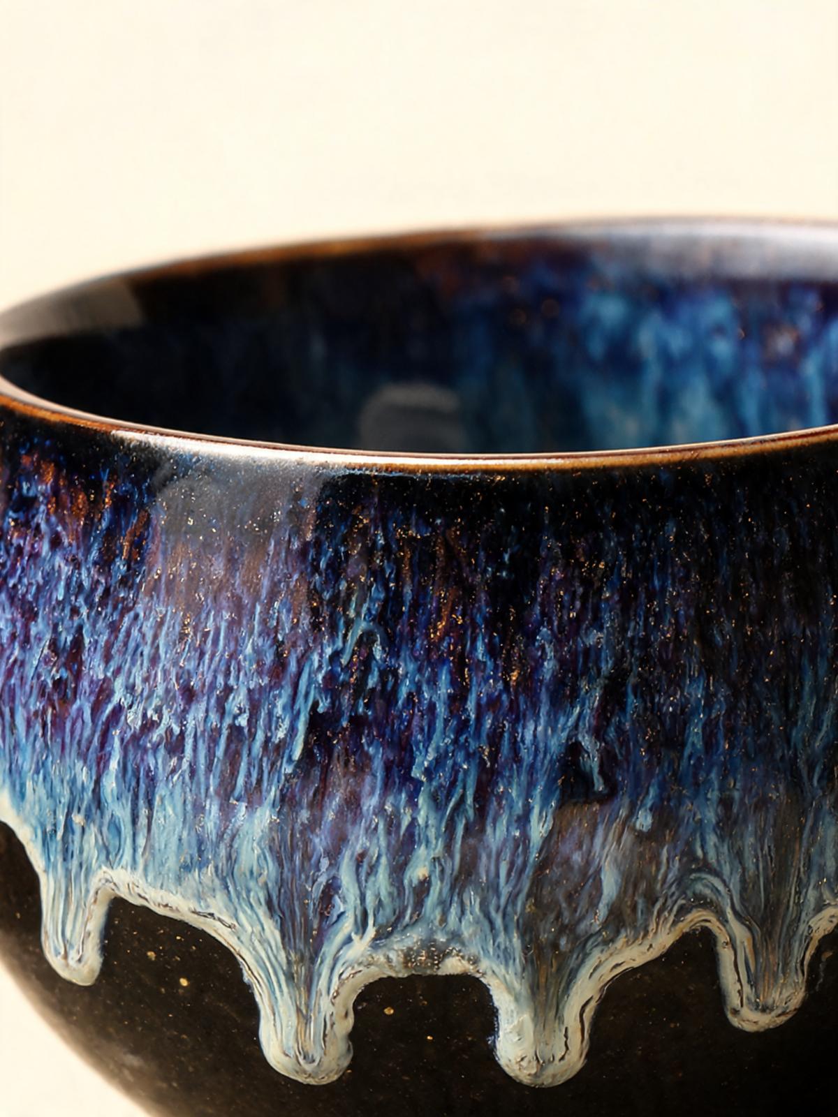 Detail of the golden mineral speckles across the indigo glaze