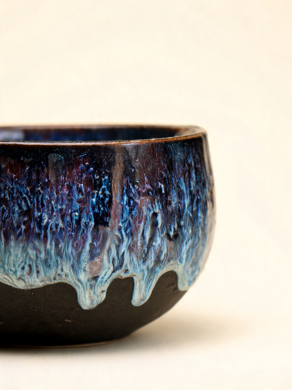 Detail of the indigo, blue and violet reactive glaze flow