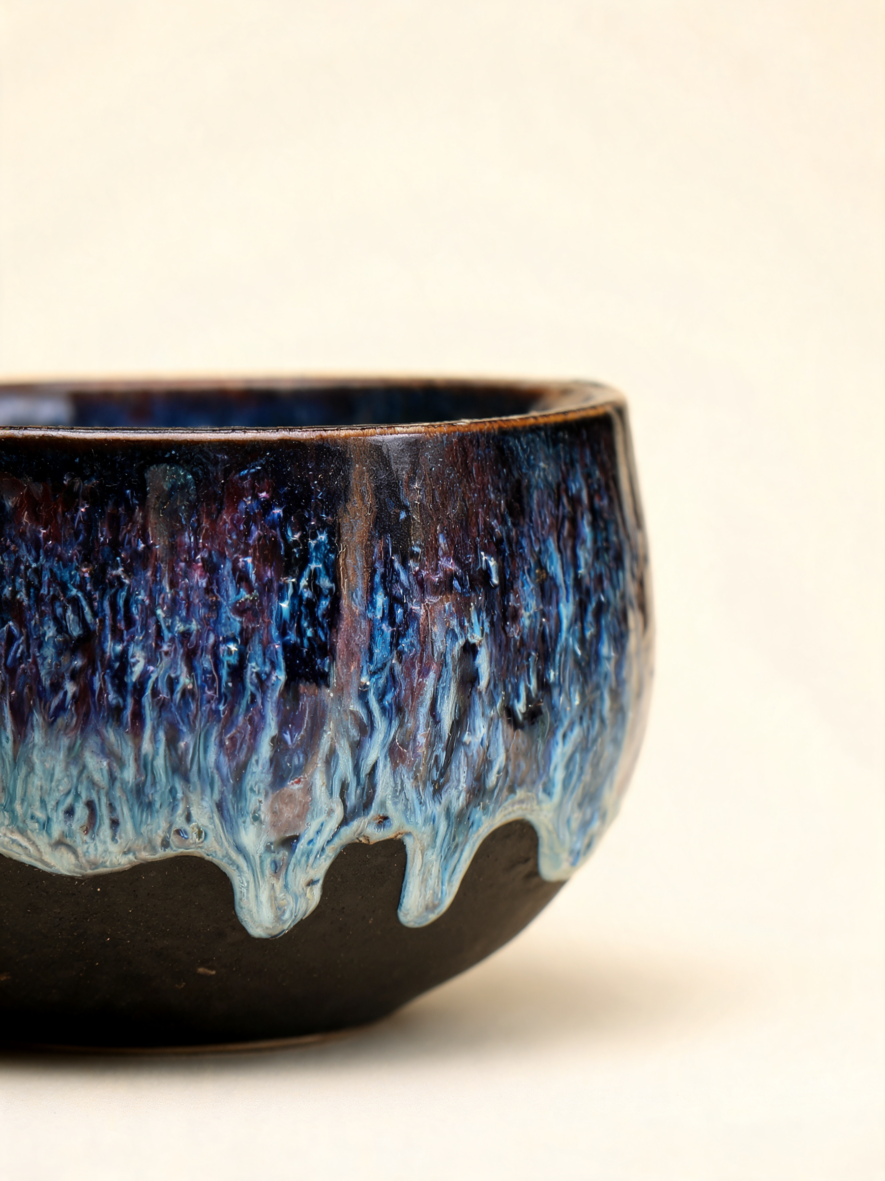 Detail of the indigo, blue and violet reactive glaze flow